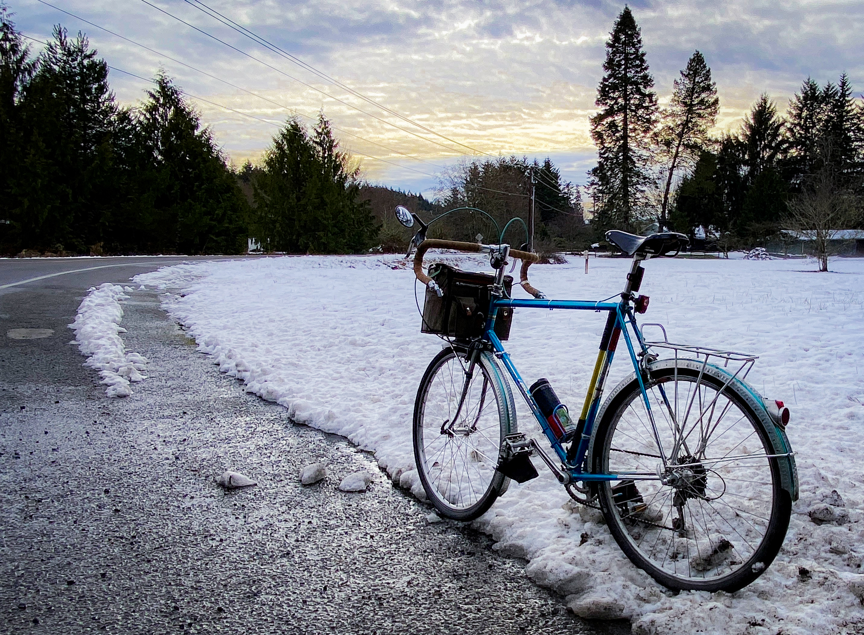 Snow along road with a bicycle